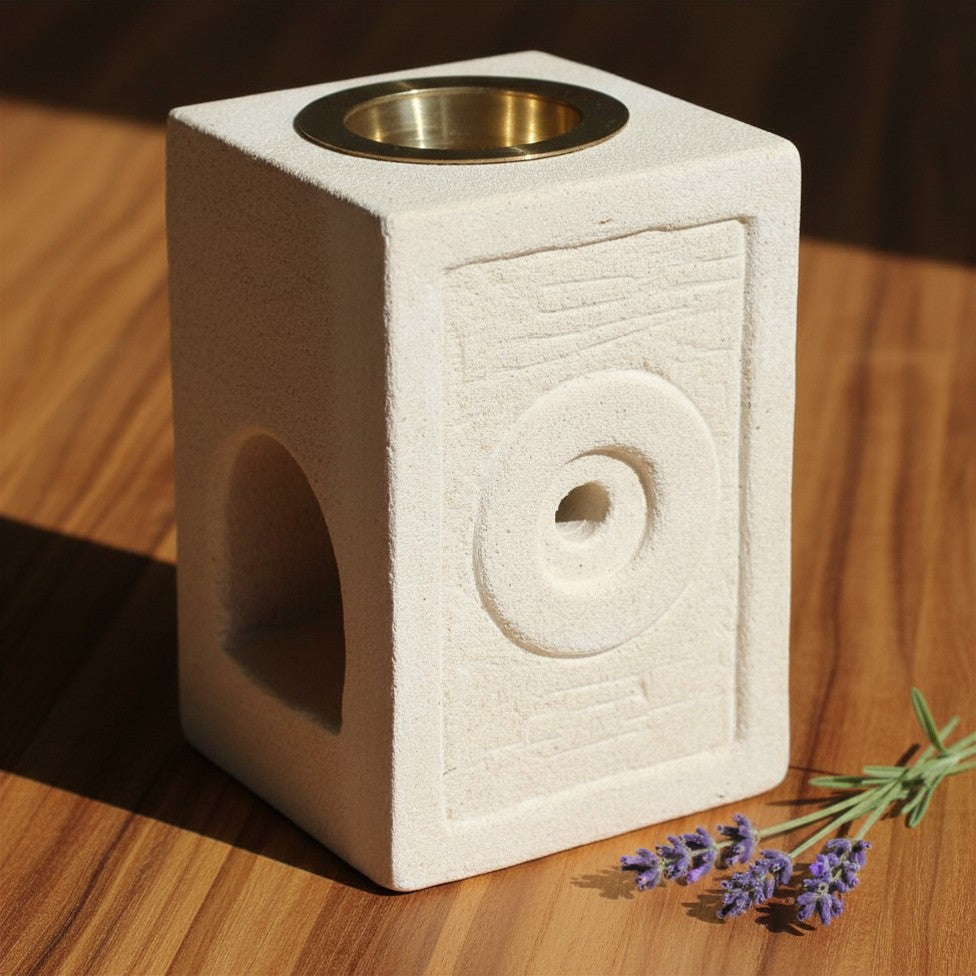 Moorish-inspired square stone oil burner carved from solid Indonesian sandstone with a glass dish.