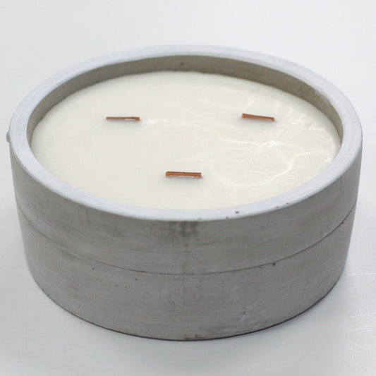 Large Patchouli & Dark Amber botanical wood-wick candle in a minimalist raw concrete bowl.