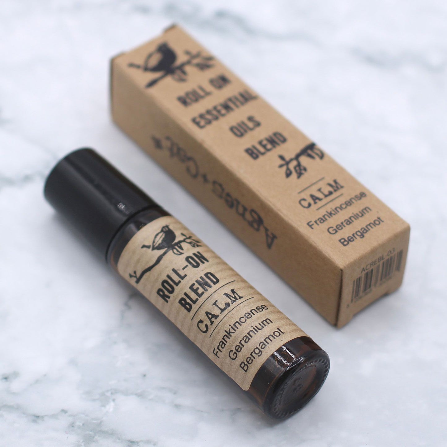 Calm Essential Oil Pulse Point Roller in an amber glass bottle with kraft packaging.