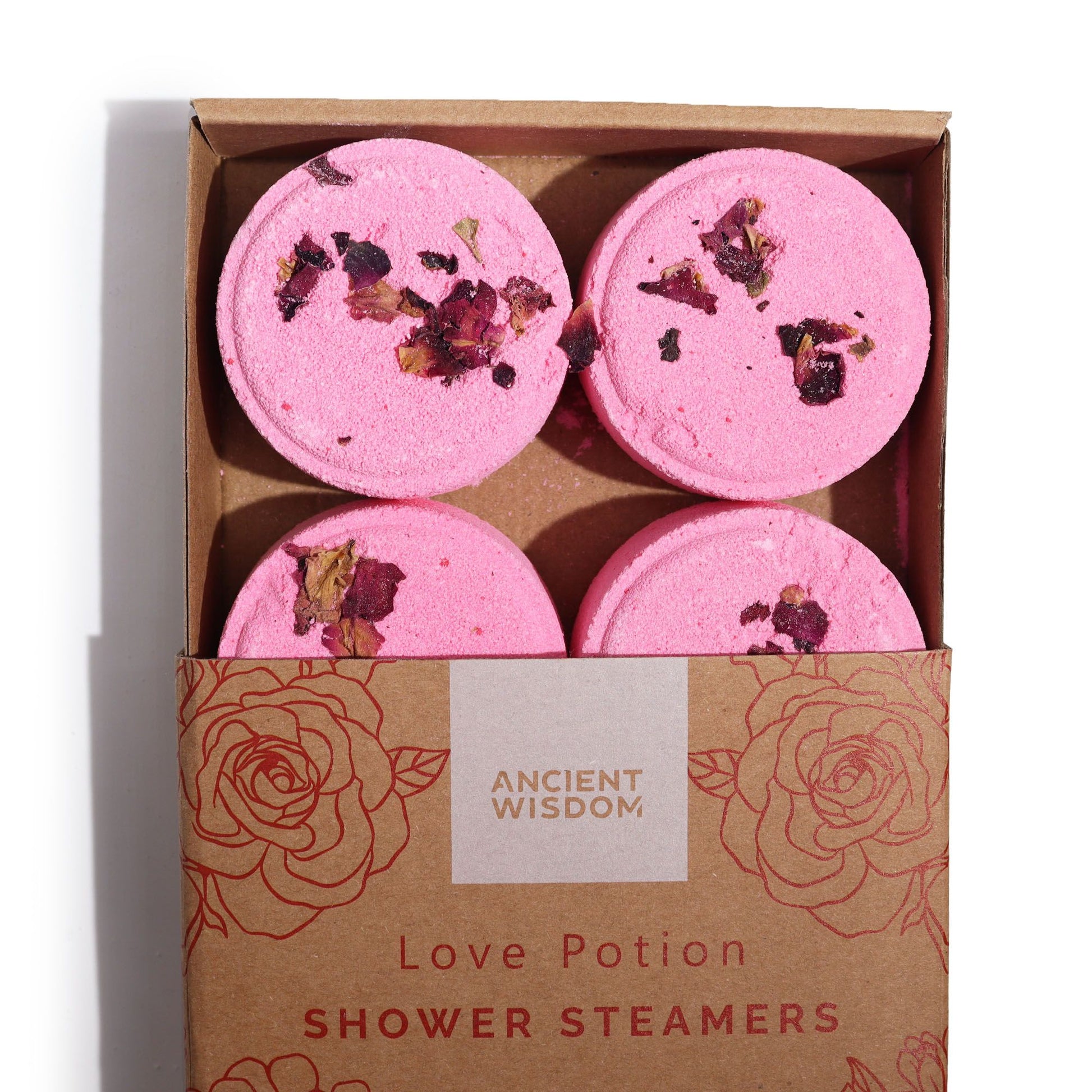 Set of four Balancing Botanical Shower Steamers topped with rose petals in a kraft gift box.