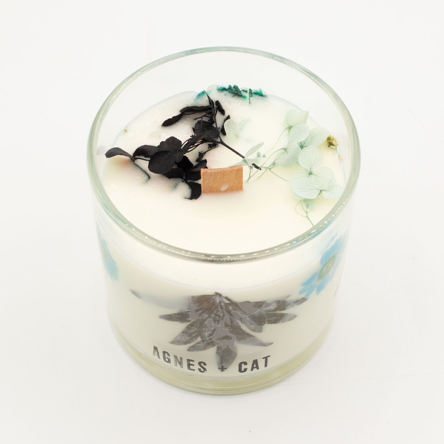 Agnes + Cat Sea Salt & Moss botanical soy wax candle in a glass jar, featuring real dried botanicals and a natural wood wick for a clean burn.