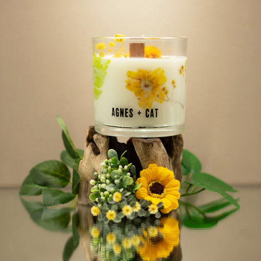 Agnes + Cat Rydal Oudh botanical soy wax candle with embedded dried flowers, wooden wick, and gift box featuring hand-drawn artwork.