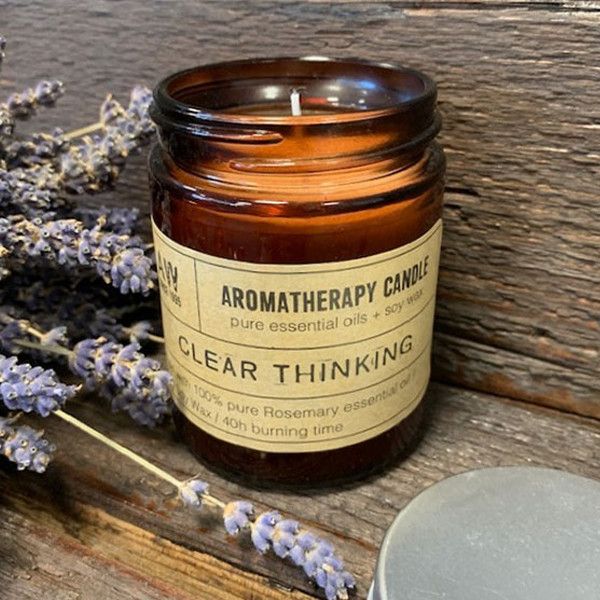 Hand-poured Pure Rosemary botanical candle in a classic amber glass apothecary jar.
