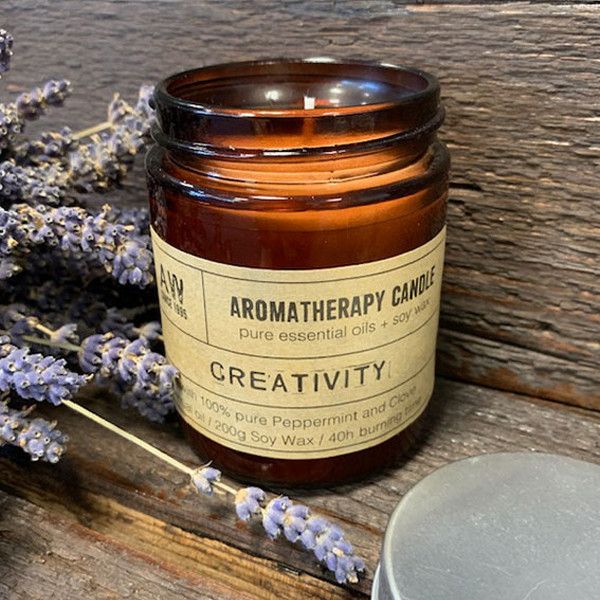 Hand-poured Peppermint & Clove soy wax candle in an amber glass apothecary jar.