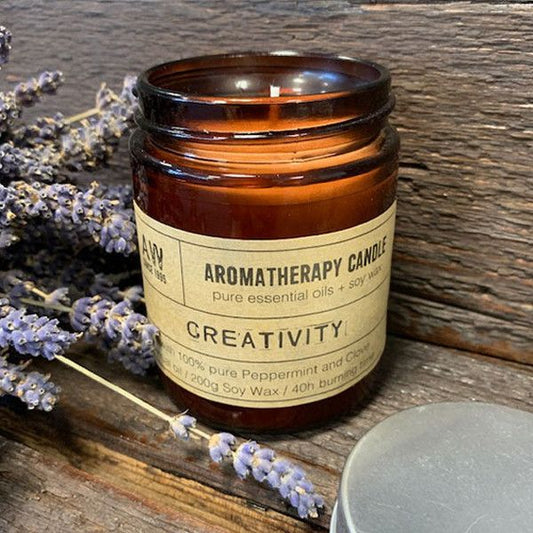 Hand-poured Peppermint & Clove soy wax candle in an amber glass apothecary jar.