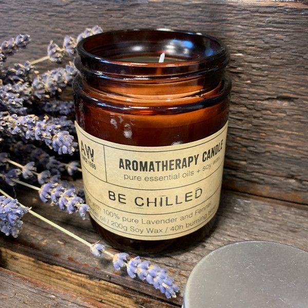 Hand-poured Lavender & Fennel botanical candle in a classic amber glass jar.